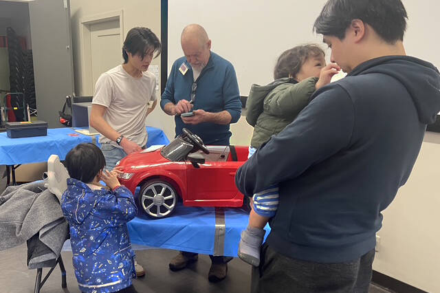 A family waits for repairs to a young member&rsquo;s toy car, during a previous Repair Café at Alex House in South Surrey. (File photo)