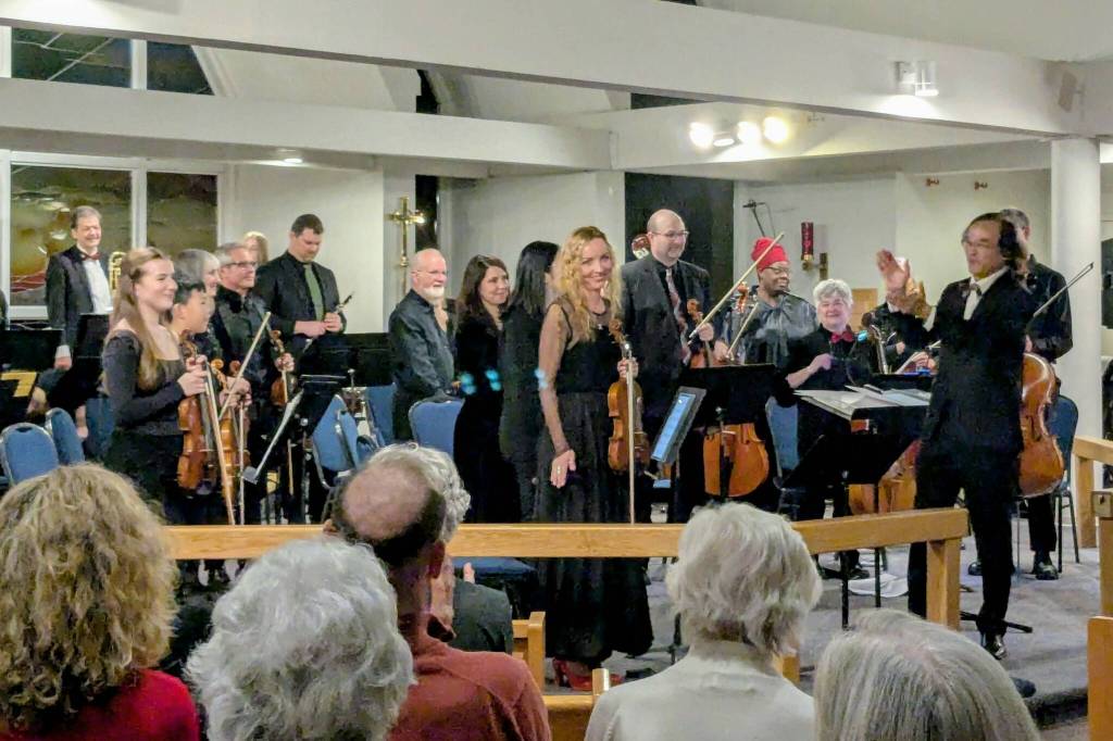 Concert master Monika Niedzielko (centre) and members of the White Rock City Orchestra are acknowledged by guest conductor Jin Zhang (at right) at the conclusion of their last concert, Dec. 12, at St. Mark&rsquo;s Anglican Church in South Surrey. The orchestra returns to the same venue on March 21 for Echoes from an Exhibition. (Alex Browne/Peace Arch News)